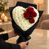 Eternal Love heart-shaped bouquet of white chrysanthemums and red roses being presented as a romantic gift
