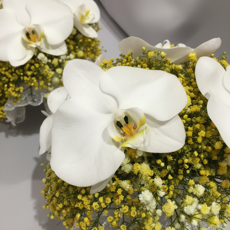 Close-up detail of white Phalaenopsis orchids and yellow gypsophila in the bridal bouquet