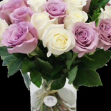 Close-up detail of white and purple rose petals in the vase arrangement