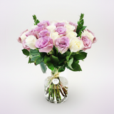 Elevated view of white and purple roses in a vase