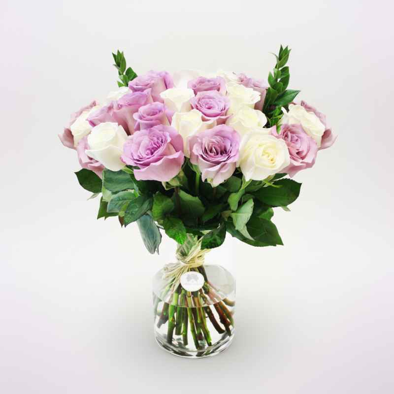 Elevated view of white and purple roses in a vase