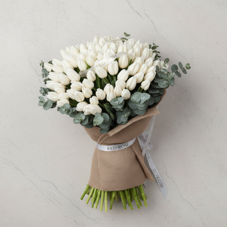Top-down view of premium white tulip arrangement