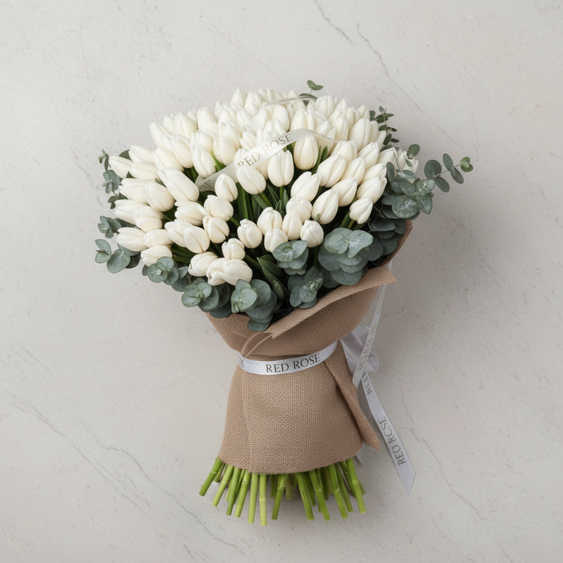 Top-down view of premium white tulip arrangement
