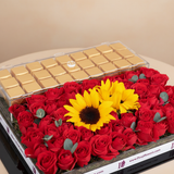 Close-up of roses sunflowers and chocolates in gold tray