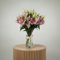 Lilliam Oriental flowers 7 pieces arranged in a clear vase with a decorative ribbon
