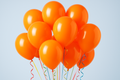 Orange helium balloons bunch