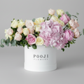 Pink Petite arrangement with Pooji Flowers branding