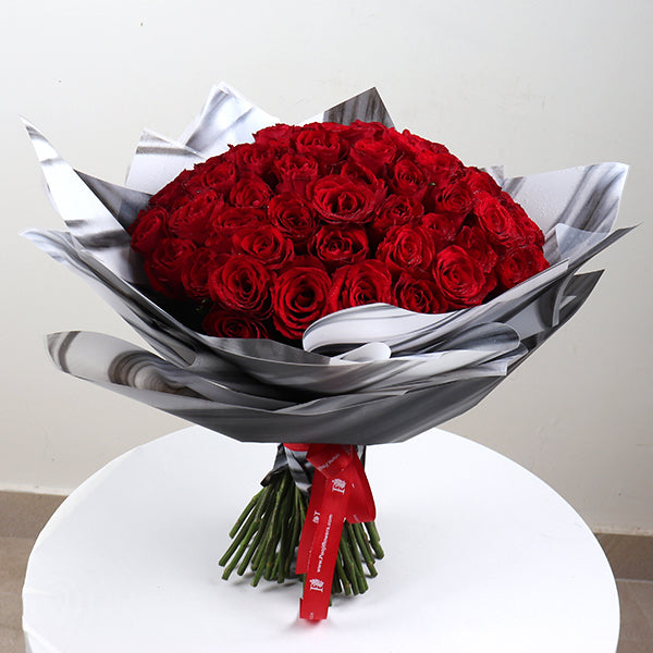 Stunning Red Roses Bouquet Chocolate beautifully arranged with lush green stems