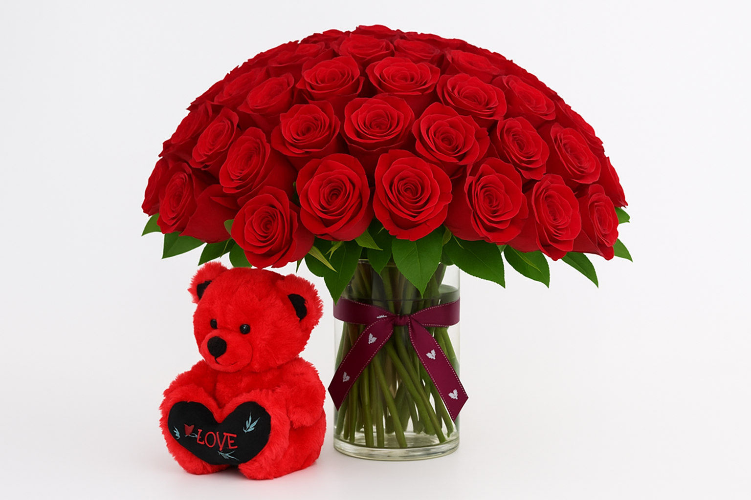 Side angle view of 100 roses with teddy bear