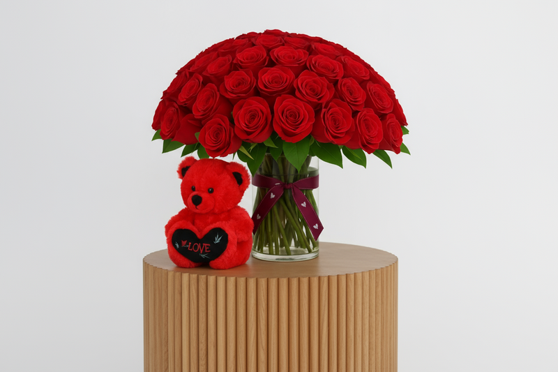 Side angle view of 100 roses with teddy bear