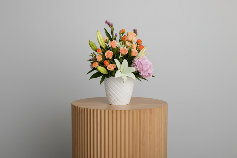 Bouquet of flowers in a white vase on a light gray background