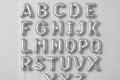 Silver helium balloons in the shape of letters A through Z in a square format