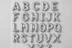 Silver helium balloons in the shape of letters A through Z in a square format