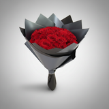 Three-quarter view of a 25 red roses hand bouquet wrapped in black paper