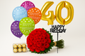 Birthday arrangement with red roses, colorful balloons, and a 40 Inch gold balloon on a white background.