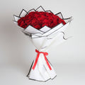 Elegant Valentine Day bouquet featuring vibrant red roses with stylish black and white wrapping